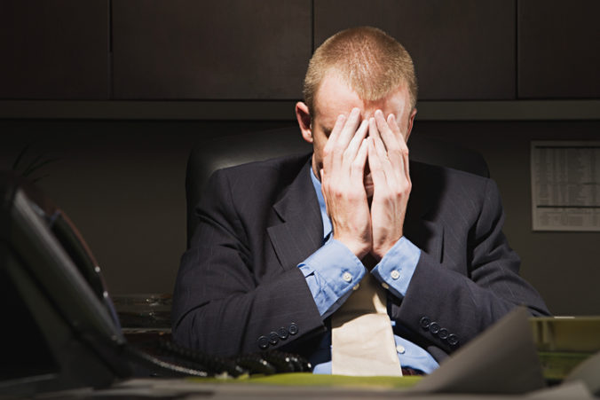 Businessman with his head in his hands