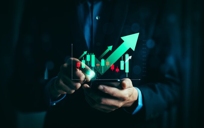 Businessman analyzing bullish stock market trend on smartphone with rising candlestick chart and green arrow growth indicators, concept of trading, investment success, financial analytics, and profit