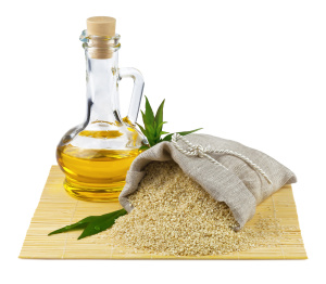 Sack of sesame seeds and glass bottle of oil
