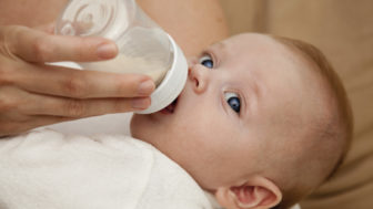 Mother feeding newborn son