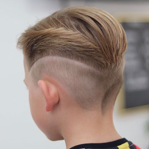 Slicked back hair with mid fade and design.jpg