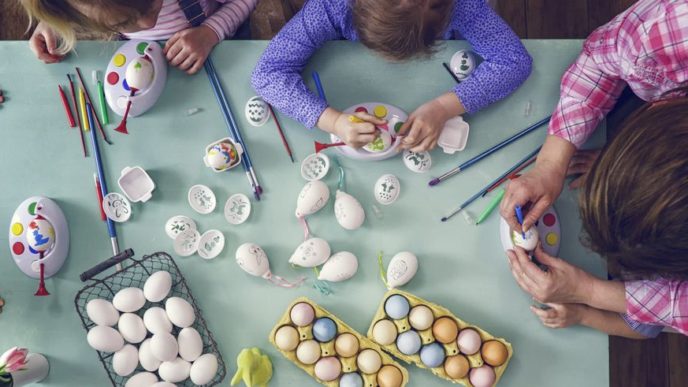 Kids painting easter eggs royalty free image 645980914 1551798969.jpg
