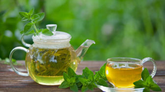 Delicious green tea in a beautiful glass bowl on a table