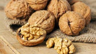 Walnuts on wood background