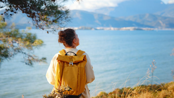 Travel And Active Lifestyle Concept. Happy Smiling Woman Hiking