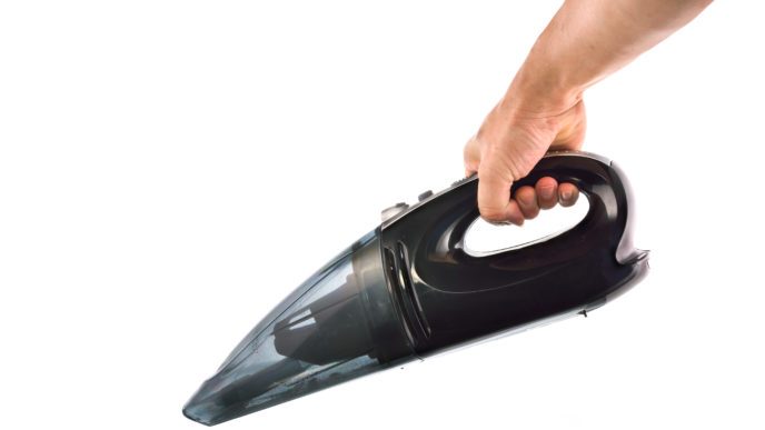 Hand hold vacuum cleaner on white background