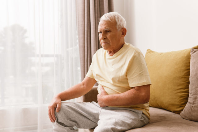 Senior man is suffering from problems with a digestion