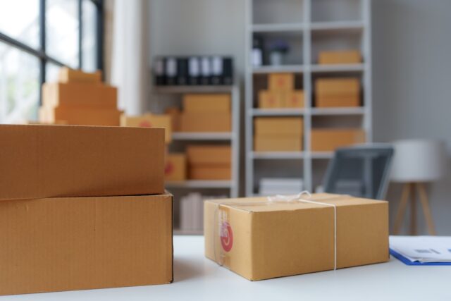 Cardboard boxes are stacked and ready for shipping in a warehouse or office, demonstrating the concept of e commerce, logistics, and distribution