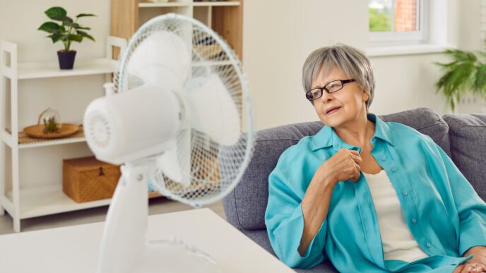 seniorka sedí pri zapnutom ventilátore