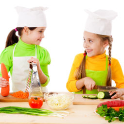 Two girls making salad