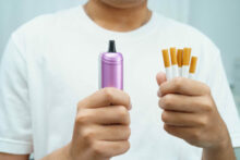 Man holding electronic cigarettes, no smoking.