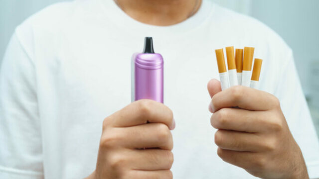 Man holding electronic cigarettes, no smoking.