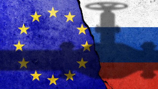 Flag of Europe Union and Russia painted on a concrete wall with gas pipe shadow. Relationship between EU and Russia