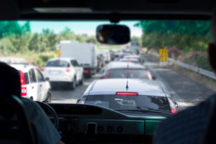 Driving minivan, traffic jam ahead, blurred shot with particular focus