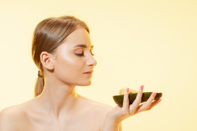 Inspired. Close up of beautiful young woman face over white background. Cosmetics and makeup, natural and eco treatment, skin care