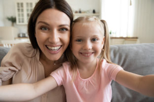 Happy young mom and little daughter