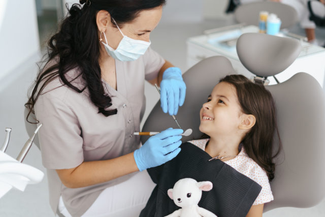 Little beautiful girl at the dentist smiling