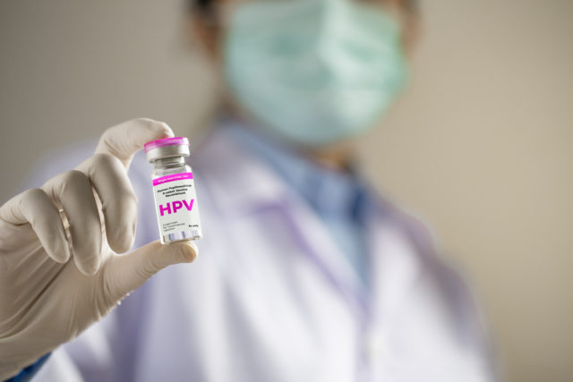 HPV (Human Papillomavirus) Doctor or scientist holding liquid vaccines HPV vaccine. viruses Some strains infect genitals and can cause cervical cancer.