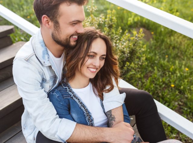 Content loving couple embracing on steps