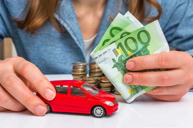 Businesswoman With Money And Toy Red Car In Hands