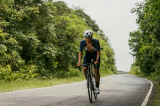 Groups of cyclists riding road bikes in the morning are climbing.