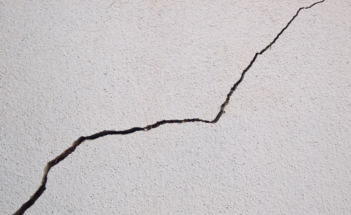 Cracked concrete texture closeup background