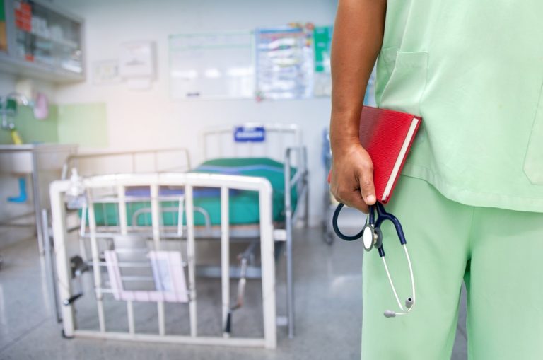 Close up unknown nurse holding stethoscope in hospital