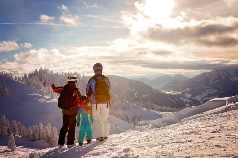 Happy family in winter clothing at the ski resort