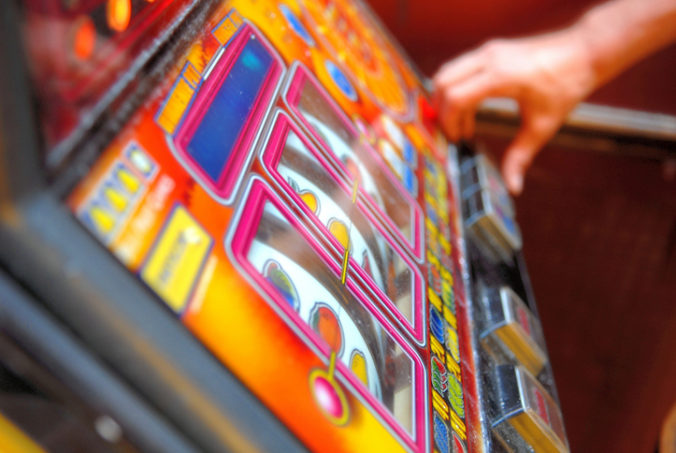 Mid adult playing on gambling machine