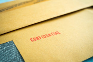 "Confidential" printed on brown vintage envelope, in macro