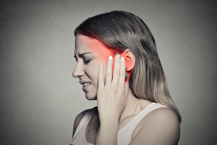 Side profile sick female having ear pain touching head