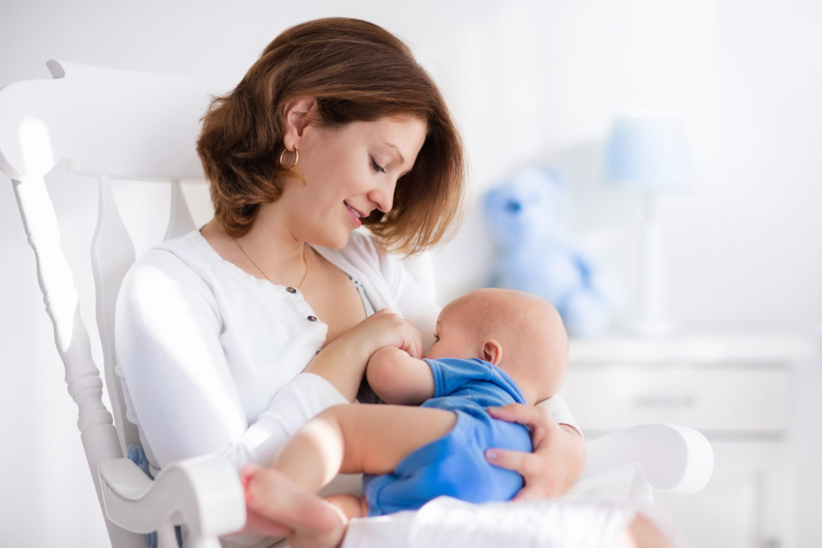 Nice young mother with baby boy at home