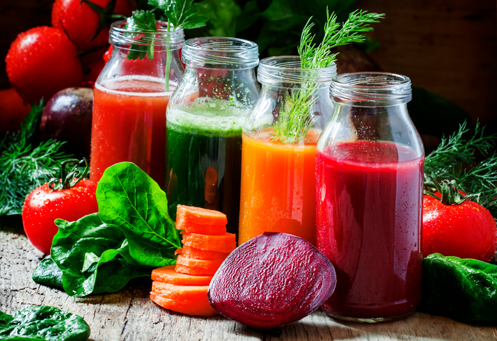 Four kind of vegetable juices: red, burgundy, orange, green