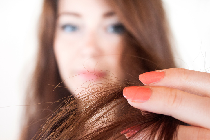 Girl shows her damaged hair