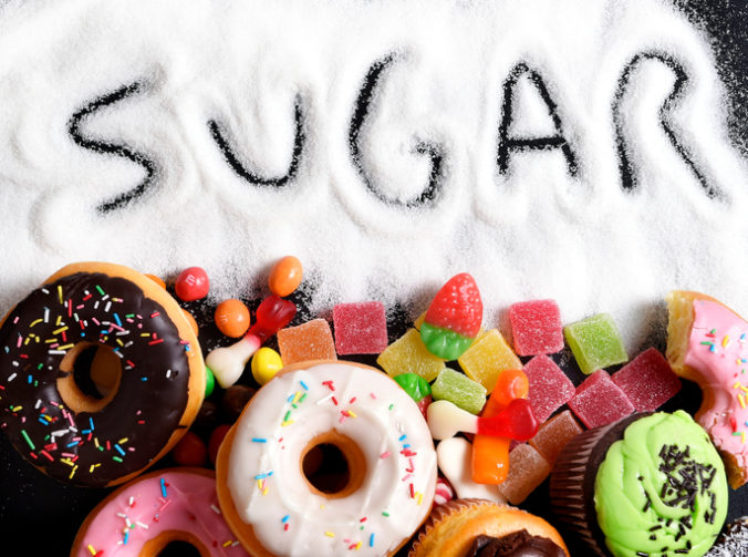 Mix of sweet cakes, donuts and candy with sugar text