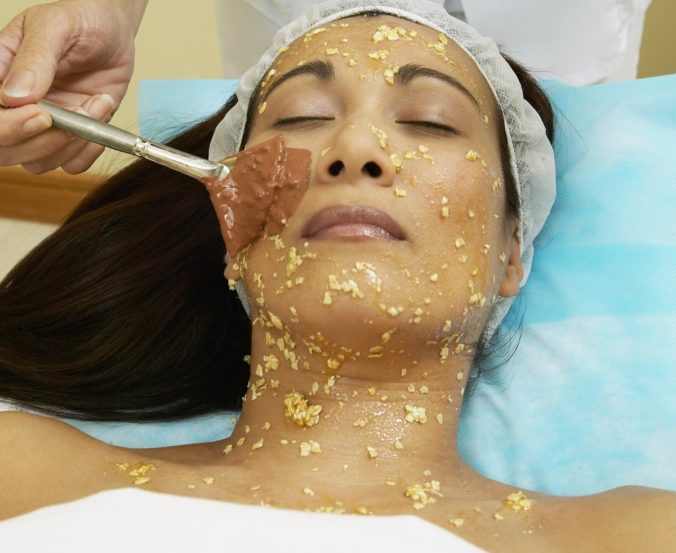 Asian woman receiving facial spa treatment