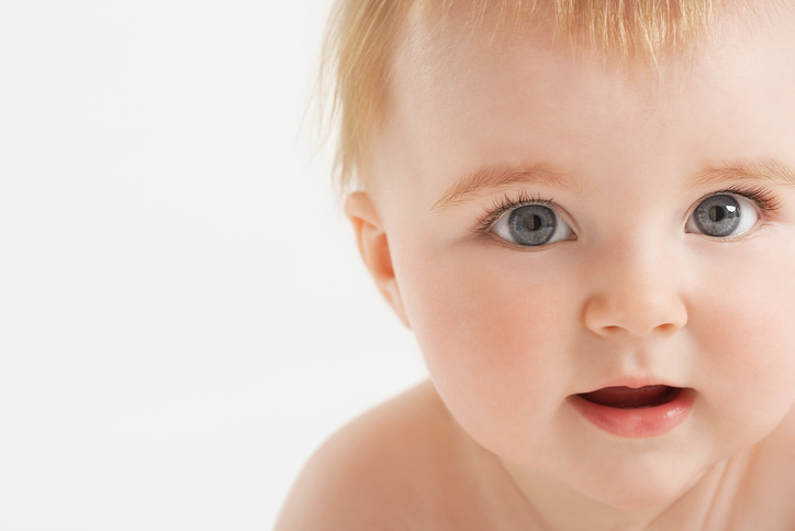 Baby with fuzzy hair and open mouth