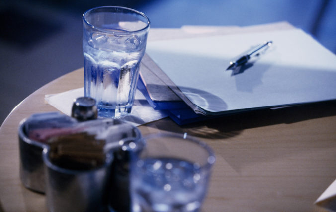 Table with glasses and a pen and paper