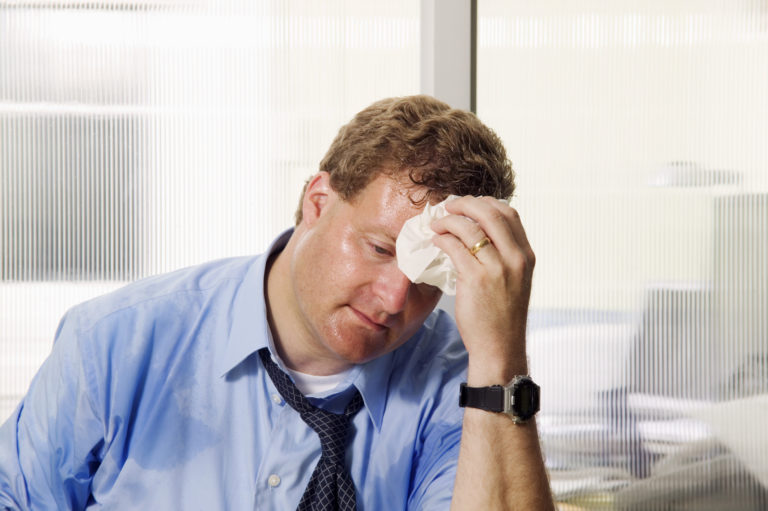 Businessman wiping his brow