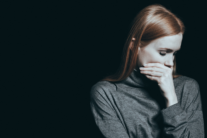 Bulimic woman covering her mouth
