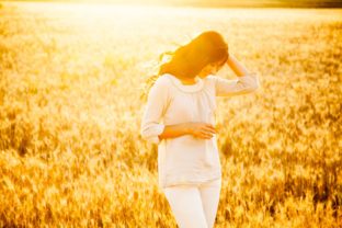 Beautiful brunette lady in wheat field at sunset_shutterstock_197635442.jpg