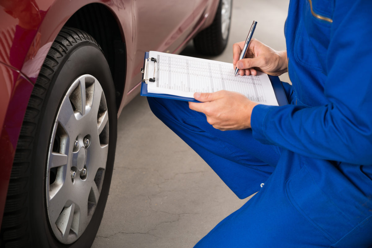 Mechanic Examining Car Wheel
