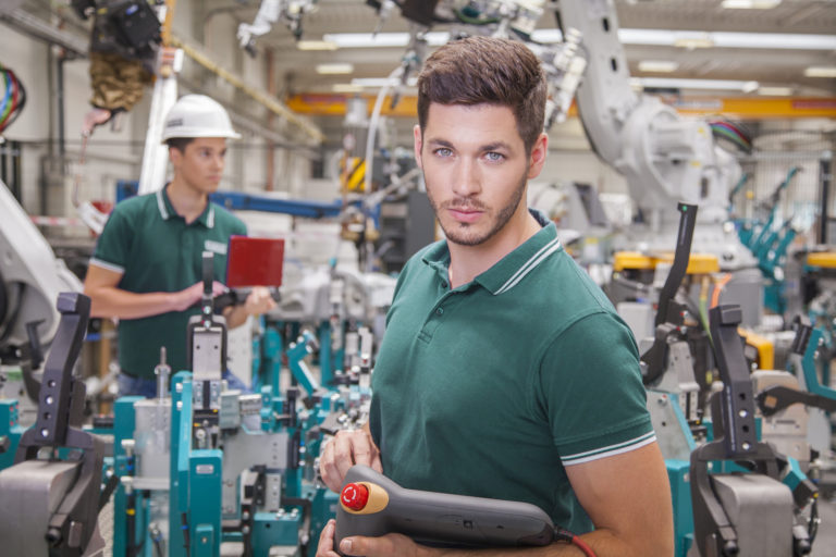 Maintenance technicians team while programming robots