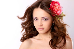 Pretty girl with long hair and flower hairpin
