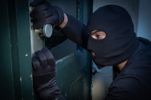 Burglar trying to force a door lock