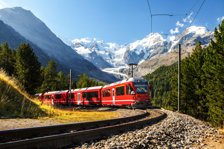 Swiss train in the alps mountains in switzerland around ospizio bernina