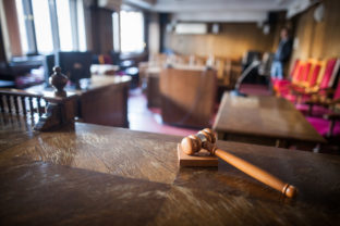 Color image of a hammer in a courtroom.