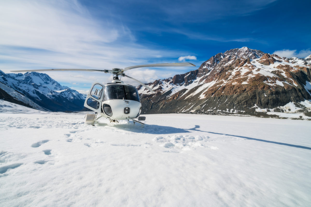Helicopter Landing on a Snow Mountain