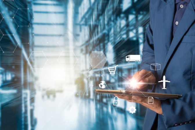 Business Logistics concept, Businessman manager using tablet check and control for workers with Modern Trade warehouse logistics. Industry 4.0 concept