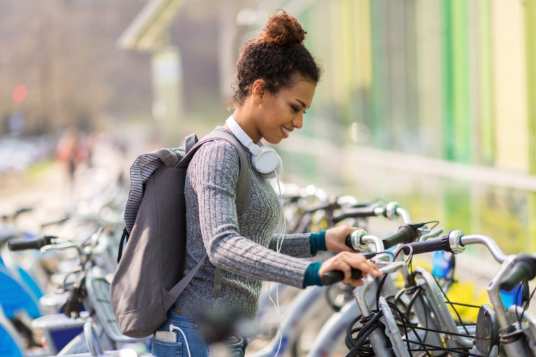 Young woman renting bicycle